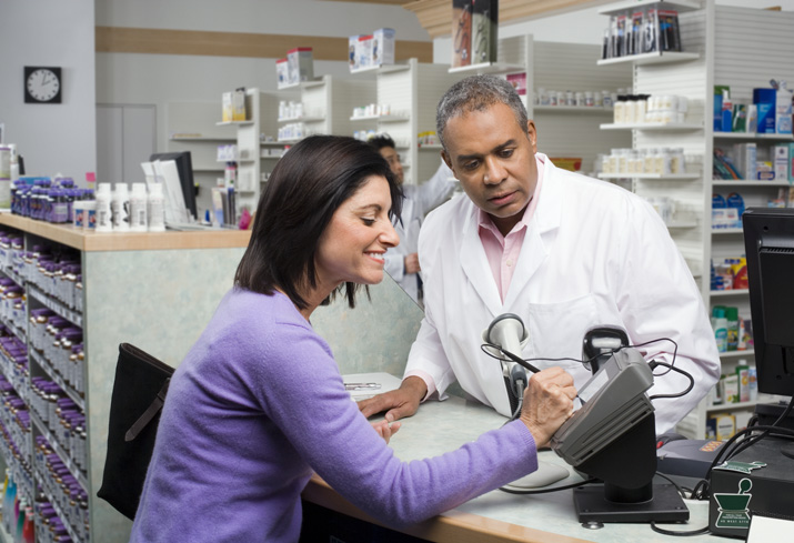 Pharmacist with customer at counter.JPG